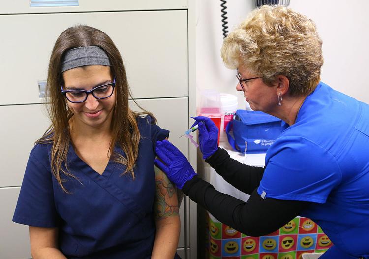 Betsy Worden, right, administers a flu shot to Allison Chaplin at St. Vincent Kokomo. Staff photo by Kelly Lafferty Gerber