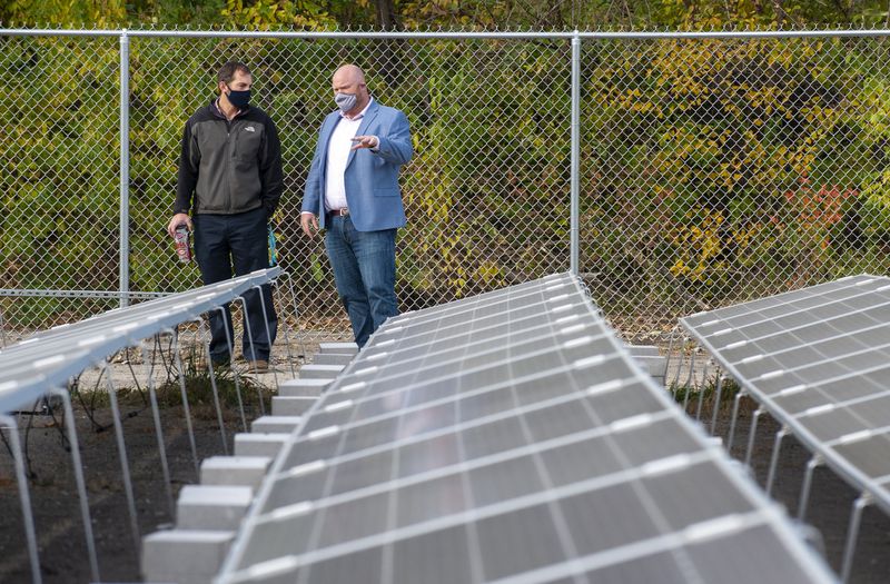 Sun FunED co-founder Patrick Poer, right, speaks with Scott Cvelbar at the 2,000 kilowatt solar farm outside the Neighbors Educational Opportunities school in Portage Thursday Nov. 5, 2020. Andy Lavalley/Post-Tribune (Post-Tribune)