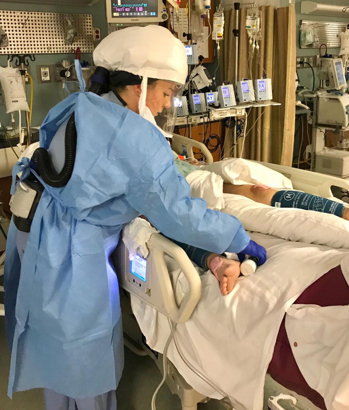 Ali Iavagnilio, a registered nurse at Memorial Hospital, treats a COVID-19 patient Wednesday inside one of the hospital’s coronavirus units. Provided photo