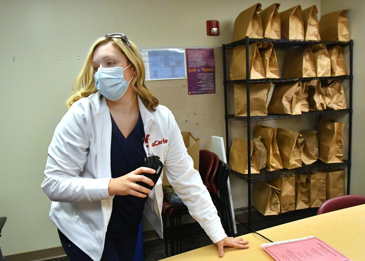 Melissa Reidy, clinical coordinator at Carle BroMenn Medical Center in Normal, Illinois, said she's never seen the kind of strain on staff she's seeing now. To the right are bags of personal protective equipment worn by staff. DAVID PROEBER, THE PANTAGRAPH