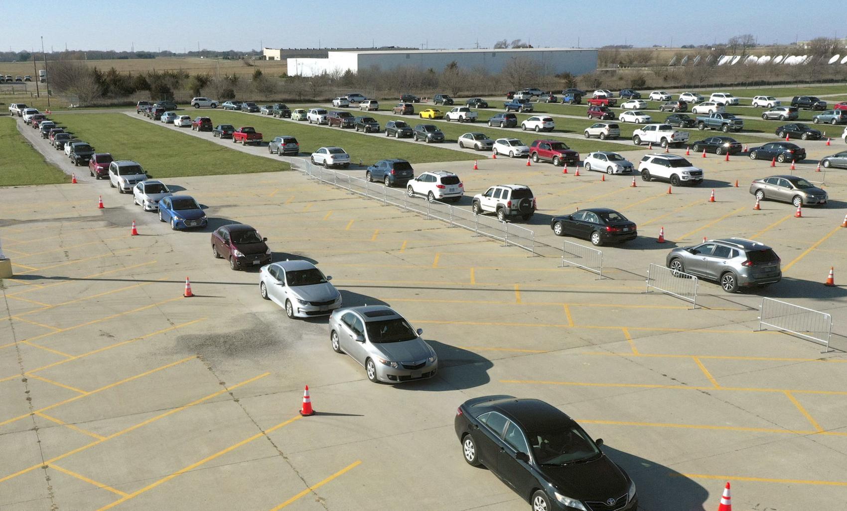 More than 100 vehicles line up as people wait to be tested for the virus at a Reditus Laboratories testing site in Bloomington, Illinois. DAVID PROEBER, THE PANTAGRAPH
