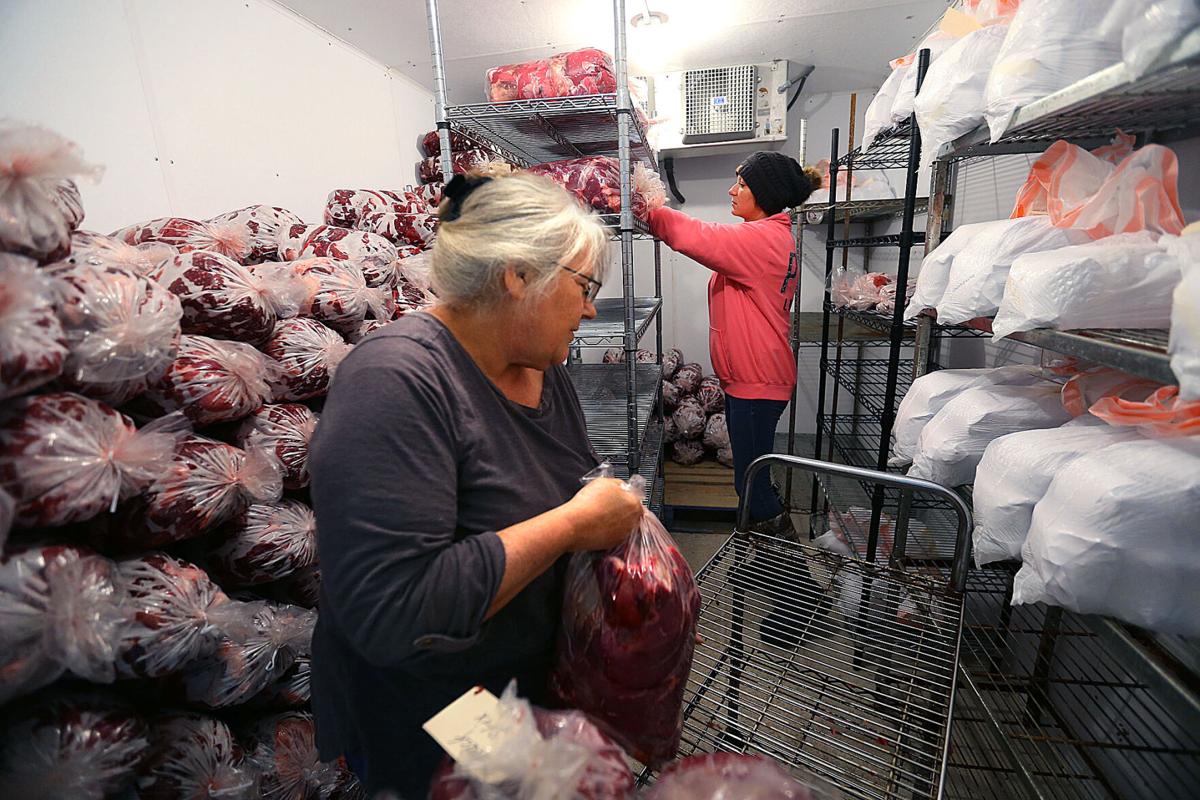 Tosha Larke and Connie Jackson stack begs of meat in the freezer at Frank Simpson’s deer processing business in Young America on Nov. 24, 2020. Staff photo by Tim Bath
