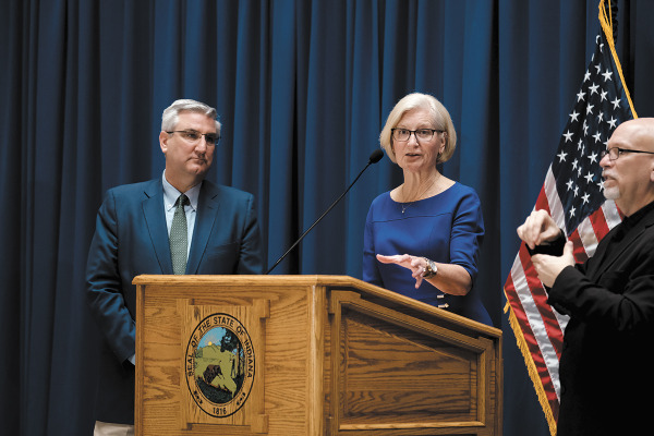 Dr. Kris Box, the state’s health commissioner, and Gov. Eric Holcomb, held daily Statehouse briefings at the start of the pandemic but soon moved to virtual events. Over time, they reduced the briefings to once per week. (IBJ file photo)
