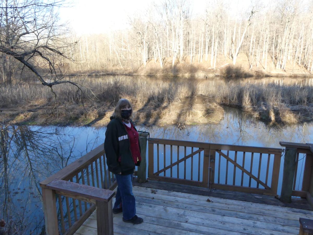 The view from Nan Kirby’s dock has changed drastically over the past two decades. The island behind her has formed over time and filled in the portion of Lake Hollybrook near her home. Staff photo by Laura Lane