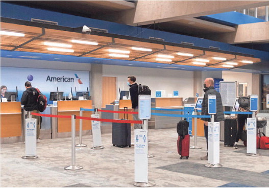 travelers check-in for their flight with American Airlines at the Evansville Regional Airport on Wednesday morning. MaCabe Brown staff photo