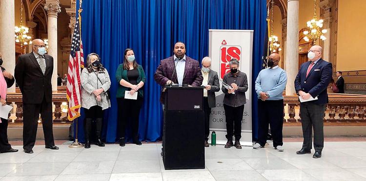 Marshawn Wolley, center, and several other education and civil rights advocates gather at the Statehouse on Jan. 19 to rally against HB 1134, a “parent transparency” bill they say would limit classroom lessons on racism. Photo by Whitney Downard | CNHI Statehouse Reporter