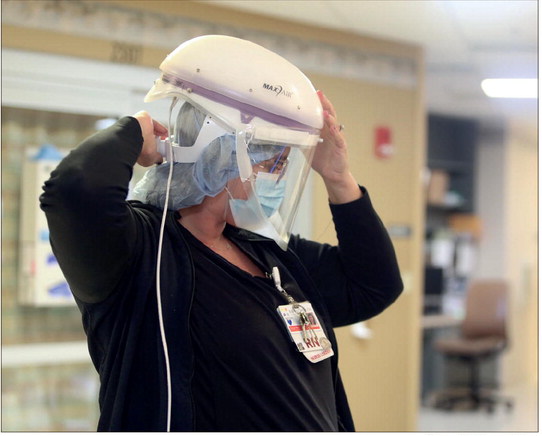 Baptist Health Floyd Charge Nurse Brooke Hanger-Yates puts on her CAPR, a piece of respiratory protection equipment in this Sept. 7, 2021 staff file photo by Makenna Hall | News and Tribune