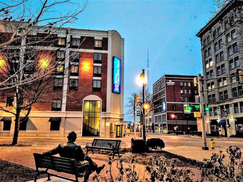 Some company: Crows fly overhead, perch in trees and rest atop buildings around the Max Ehrmann Crossroads of America plaza downtown on a Thursday morning last month. Sidewalks bear the evidence. Staff photo by Mark Bennett