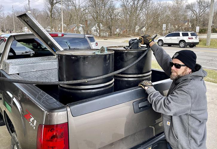 Spencer Stohler fills a pair of 50-gallon drums with gas at the GetGo convenience market in Edgewood. Stohler said Tuesday that he plans to store the drums so he’ll have gas on hand for his lawn care equipment, ATVs and other vehicles during the next few months. It cost Stohler nearly $450 to fill both barrels and his pickup. Andy Knight | The Herald Bulletin