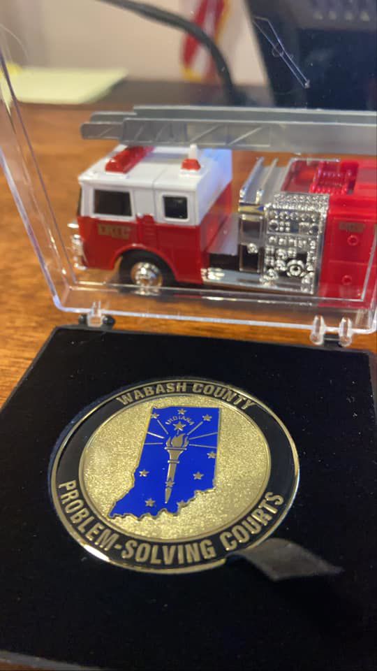Gradates from the three 'Problem-Solving Courts' in Wabash County receive a toy fire truck to mark the history of the local program. Photo provided by Brian Swihart