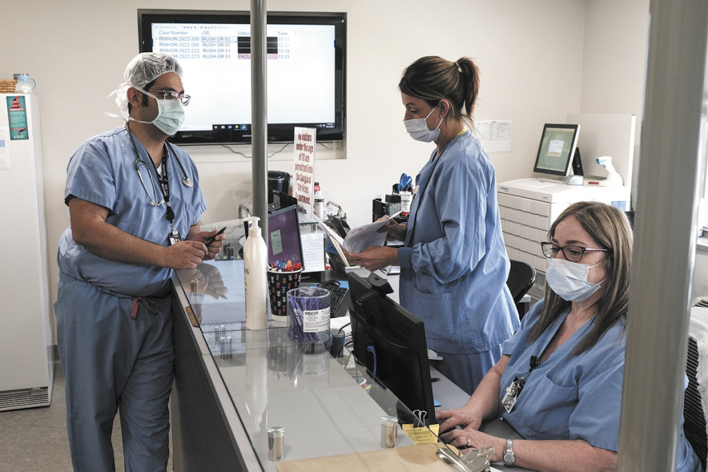 Anesthesiologist Dr. Sahba Charkhzarrin and patient care technician Lora Littrell talk at Rush Memorial Hospital in Rushville. Officials at the 25-bed hospital say the pressure to provide services without losing money is relentless. (IBJ photo/Eric Learned)