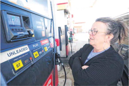 Lynnette Goodwin waits while pumping gas at a local station in Hancock County. Staff photo by Tom Russo