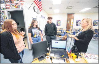 Eastern Hancock High School students Allissa Smithson, Gracie Castner and Griffin Lawrence talk with teacher Marci Gilbert. The students started VOICE right before the pandemic hit. It sputtered due to the pandemic so they’re really just getting it going now. They were the last county school to get such a program, which combats tobacco use. Monday, April 4, 2022.