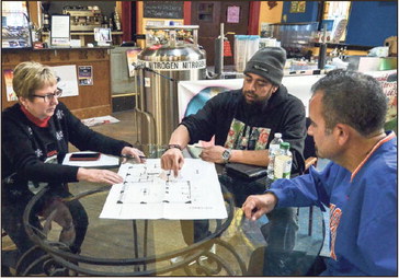 Taking the next step: Dana Simons, Next Step executive director, Chris Shelton, and Eric Diaz discuss plans for the new Next Step Cafe on Dec. 9, 2019, for when they plan to move the cafe portion of their operation to The Deming in downtown Terre Haute. Tribune-Star file/Austen Leake