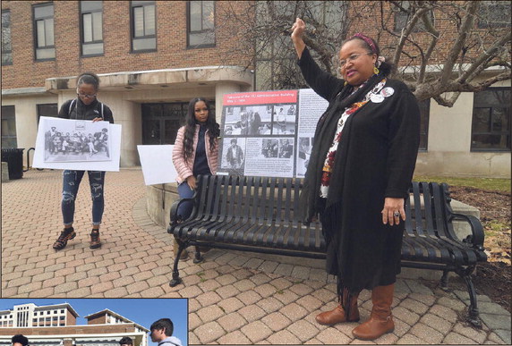 A symbol often seen in the ‘60s: Crystal Reynolds displays the Black Power fist as she points out a white student in a photo doing the same during the takeover of the Indiana State University administration building on May 1, 1969, during the Hidden Black History tour on the ISU campus on Thursday, Feb. 21, 2019. Students Courtney Jones and Perriel Ballard participate. Staff file photo by Joseph C. Garza
