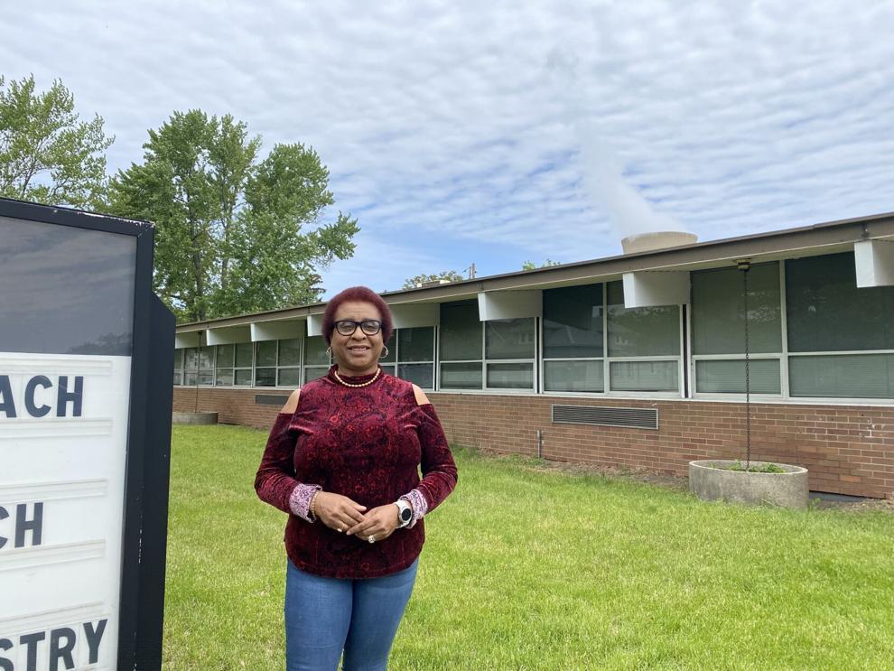 Soul Power Program Manager Donnita Scully stands in front of the NAACP LaPorte County office in Michigan City. The office sits just a few blocks from the NIPSCO Generating Station tower, visible in the background.  Molly DeVore, The Times