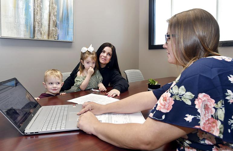 Samantha Laurie, with her two children Mak, 3, and Mila, 4, work with real estate agent Amanda Malone of F.C. Tucker/Thompson to find a home. John P. Cleary | The Herald Bulletin