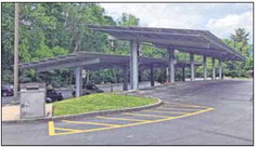 The finished power-producing solar panels. The carport-like structures were built on either side of the existing center grass median in the lower parking lot of the library. Submitted photo