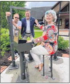 Metal artist Brad Cox, left, Sen. Eric Koch and Nashville Town Council President Nancy Crocker pose for a photo with the new interactive public art piece “Marie in the Woods” on May 27 at Coachlight Square. Cox built the piece that was commissioned by the Nashville Arts and Entertainment Commission in 2019. The dedication was delayed two years due to the COVID-19 pandemic. Democrat file photo