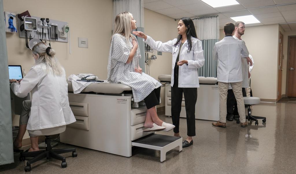 Megana Bammidi, a student in the physician assistant program at Franklin College, examines fellow student Amber Dumstorf. Their chosen profession is debating rebranding to become “physician associates” to better reflect their role in health care. (IBJ photo/Eric Learned)