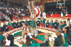 The Anderson High School Indian mascot offers up the peace pipe to those gathered around during pregame ceremonies for the kickoff of high school boys basketball in this file photo by John P. Cleary, The Herald Bulletin