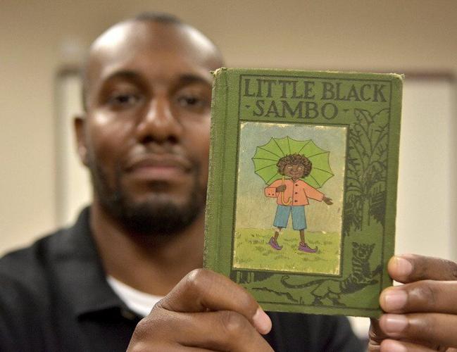 Artifacts from a different time: Even though items like this old children’s story book are offensive, Indiana State University sociology professor Adeyemi Doss believes they shouldn’t be removed from eBay so they can be used as tools to understand the impact of racism on our culture. Staff photo by Joseph C. Garza