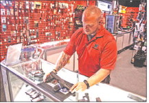 Tim Gatchell,

manager of ZX Gun Inc. in Goshen, displays two of his company’s best selling handguns Wednesday, July 6, 2022. Steve Wilson | The Goshen News