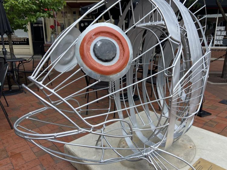 Orange Eyed Popper, by Greg Summers, is one of the summer sculptures installed around the Public Square in downtown Angola. The Mayor’s Arts Council is seeking applications for the fall installment. Staff photo by Mike Marturello