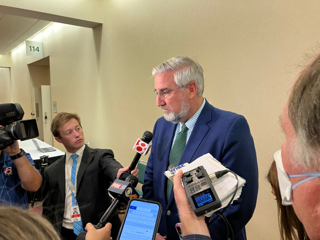 Gov. Eric Holcomb answers questions on abortion from media Tuesday at the Indiana Convention Center. (Casey Smith/Indiana Capital Chronicle)