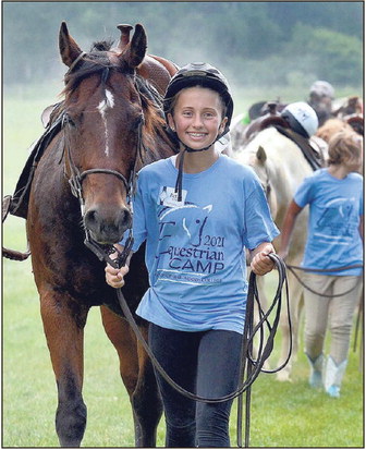 Good show, everyone: Betsy Curl of Lafayette leads her horse back to the stable as other riders do the same after a show for family and friends on June 18, 2021, during the Saint Mary-of-the-Woods College equine summer camp. Tribune-Star file/Joseph C. Garza