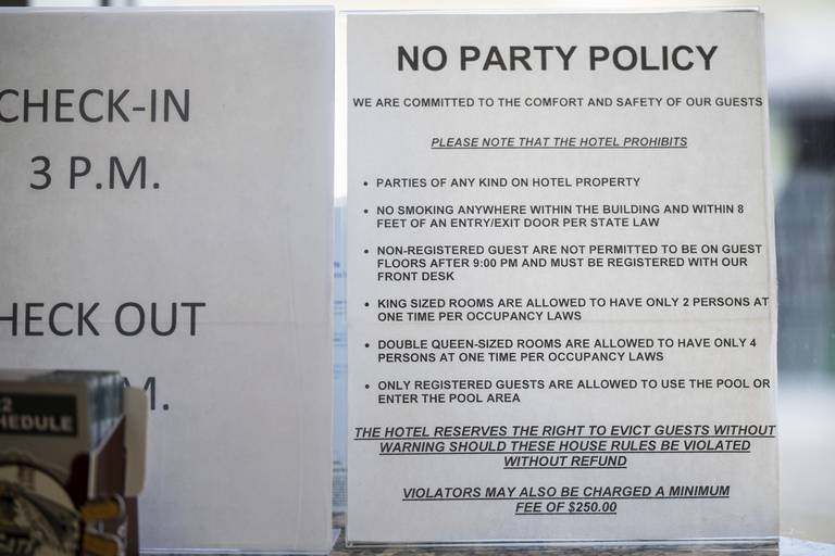 A sign warning customers of the hotel's "No Party Policy" sits on the front desk of the Days Inn in Portage on Thursday, July 21, 2022. (Kyle Telechan for the Post-Tribune) 