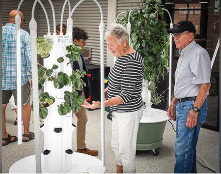 Judi Renkenberger is astonished with the Grow Studio, an indoor greenhouse at Amp Lab at Electric Works, while touring the new facility Tuesday with her husband Dave Renkenberger. Staff photo by Mike Moore