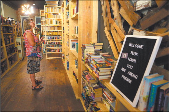 Suzy Smith looks at the shelves full of books at Chapter 2 Books in Kokomo on Thursday, July 21, 2022. Photo by Kelly Lafferty Gerber | Kokomo Tribune
