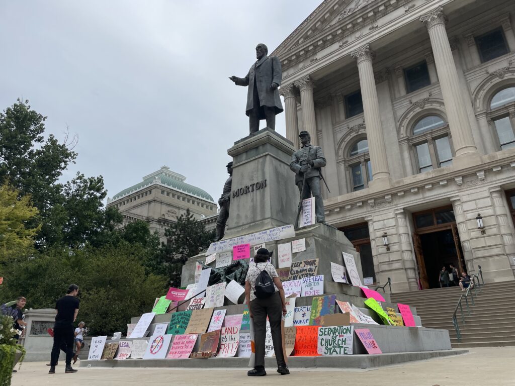 Signs left from abortion protests at the Indiana Statehouse on July 25. (Leslie Bonilla Muñiz/Indiana Capital Chronicle)
