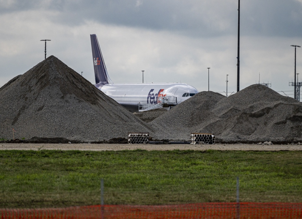 Mounds of pulverized concrete sit along Indianapolis International Airport's runway 5R/23L as part of an extensive rebuild of the strip that will occur over the next two years. (IBJ photo/Mickey Shuey)