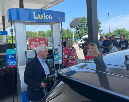 Jayme Wampler, right, watches former Vice President Mike Pence pump gas into her vehicle Aug. 2, 2022, at Luke Convenience Store & Gas Station in Hobart. Staff photo by Jerry Davich