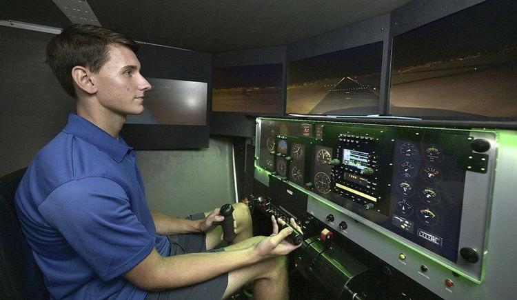 Aviation department growing: Indiana State University freshman Carson Dantzer, 18, of Fort Wayne, prepares to land in a flight simulator on Wednesday in the John T. Myers Technology Center. Dantzer, who has a double major in professional flight and aviation management, chose Indiana State over other schools that have similar aviation programs. Staff photo by Joseph C. Garza