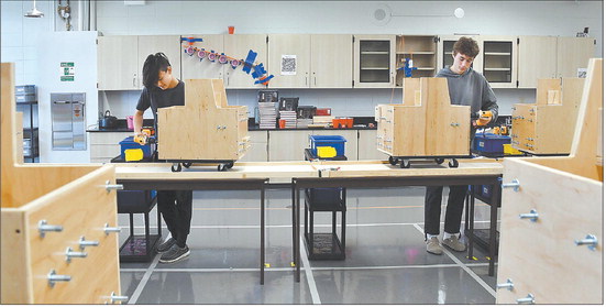 Sophomores Hayden Hester and Carson Hall do their tasks on this simulated assembly line in Alexandria-Monroe Jr.-Sr. High School’s advanced manufacturing class. John P Cleary | The Herald Bulletin