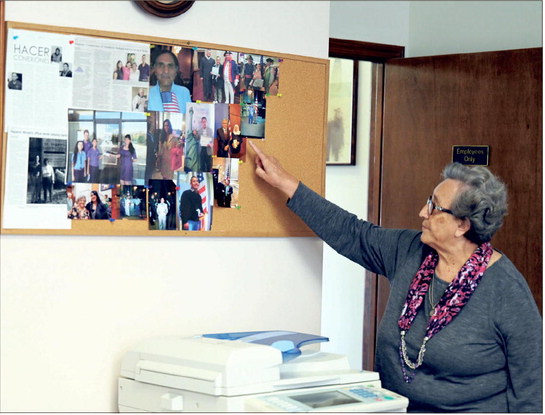 Hispanic Connection of Southern Indiana CEO Lillian Rose points to photos of clients the nonprofit has helped to gain U.S citizenship. A Capacity Building Grant from the Community Foundation of Southern Indiana will help the group continue its mission. Photo by Libby Cunningham | News and Tribune