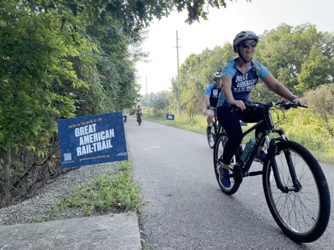Participants of the three-day bike ride across roughly 100 miles of Indiana trails approach an intersection in northern Miami County on Thursday The ride was organized by the Rails-to-Trails Conservancy. Staff photo by Jared Keever