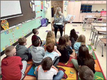 Story time: Jane Santucci reads to students as part of the United Way of the Wabash Valley Reading Neighbors program. The literacy program was made possible with support from the Vigo County School Corp. Student Learning Recovery Grant and the Elementary and Secondary School Emergency Relief (ESSER) funds. It is one of many programs aimed at addressing COVID-related learning loss. Submitted photo
