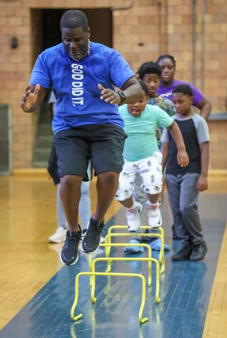 Pastor Ron Gaston from The Temple Total Fitness shows participants how to do an exercise as part of the FIT-Together program at the Michigan City Elston YMCA. Staff photo by John J. Watkins