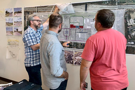 Gregg Calpino, principal with SmithGroup, left, joins architect and designer Paul Codreanu and Planning and Redevelopment Director A.J. Monroe at Portage City Hall to discuss ideas for a new master plan for the city's downtown. Doug Ross, The Times