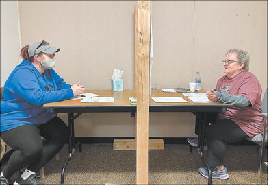 Volunteer Carol Buckner, right, meets with Jewell Thompson to help her apply for utility assistance at the Society of St. Vincent de Paul’s offices in Anderson on Thursday. St. Vincent de Paul and other local organizations continue to see high numbers of residents needing help to pay utility bills, grocery costs and other necessities. Photo by Andy Knight | The Herald Bulletin