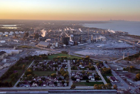 The orderly streets of Marktown and bordering parkland, in East Chicago, are shown from the southeast, with the sprawling BP Whiting Refinery behind it. A planned community nearly 100 years old, it is now slowly disappearing as BP buys and demolishes properties. Staff photo b Jonathan Milano