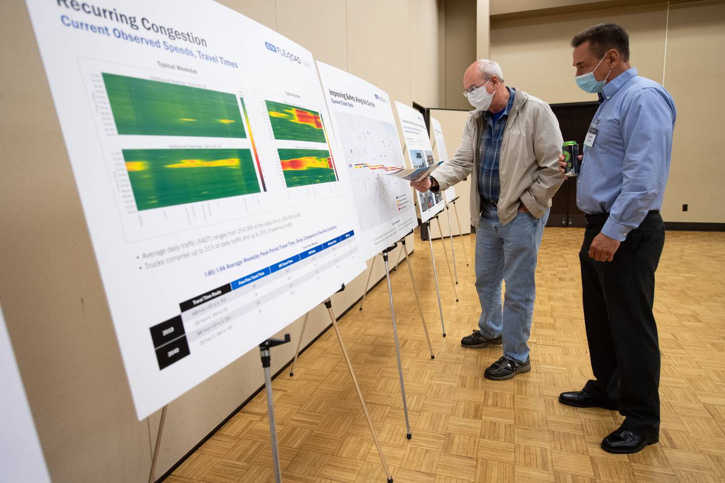 Hammond resident Dave Holeman, on left, speaks with Parsons Corporation vice president Joseph Brahm during a public meeting to gather input for a traffic study of the Borman Expressway at Purdue University Northwest in Hammond on Tuesday, October 19, 2021. (Kyle Telechan / Post-Tribune)