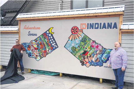 Mark Schmidt and Greg Fox unveil Schmidt’s mural behind the Brown County Visitors Center on Nov. 28. The mural was funded by a grant from Indiana Destination Development Corporation. Corbin Parmer | The Democrat