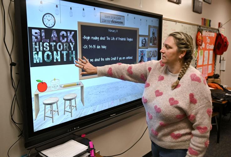 Sarah Scott Middle School eighth-grade literature

teacher Shannon Loudermilk explains how her students are able to learn about Black history with their laptops on Tuesday at the school. Tribune-Star/Joseph C. Garza
