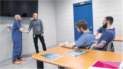 Hancock County Jail inmate Joshua Thomas, left, shakes hands with Matthew Graham, a moral reconation therapy provider, during a session at the jail on Feb. 16, 2023. Staff photo by Tom Russo