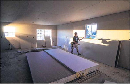 The sun sets through a window as construction on a residential home continues in Greenfield. Staff photo by Tom Russo